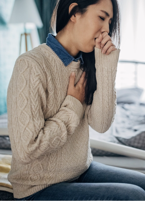 woman coughing poor indoor air quality