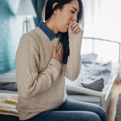 woman coughing poor indoor air quality